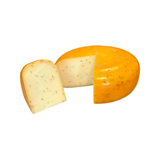 Siers ar grieķu sierāboliņa sēklām, krēmīgi dzelteni gabali uz koka dēlīša